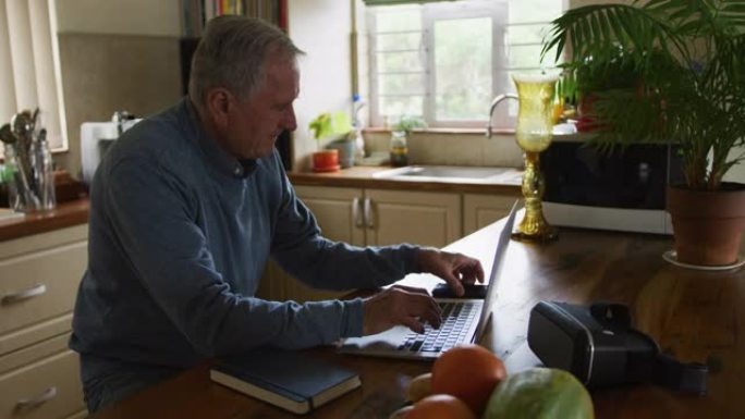 老人在家使用笔记本电脑和手机