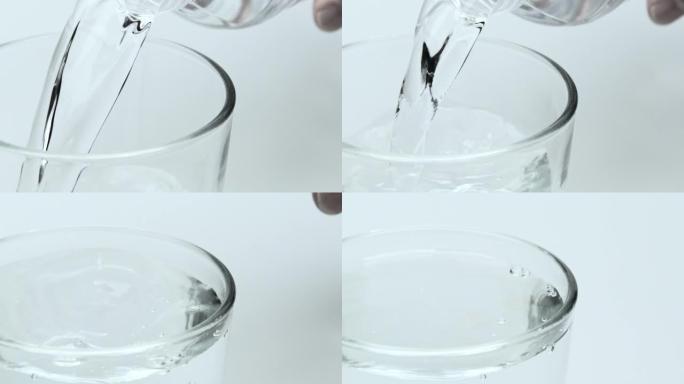 将新鲜和干净的水倒入玻璃杯中的慢动作