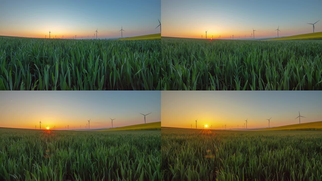 日出时在乡村旋转的风力涡轮机的运动延时镜头