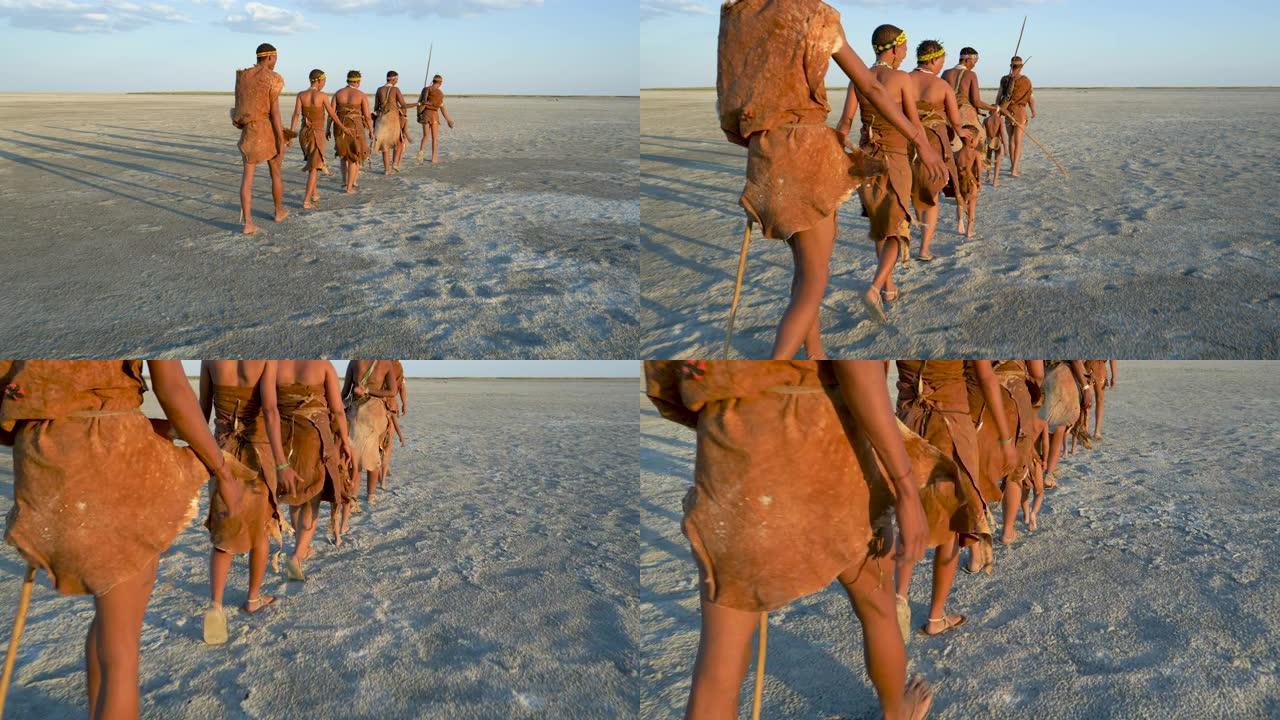一群布什曼人和孩子们在Makgadikgadi平底锅上行走