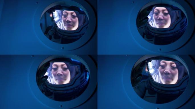 女宇航员从飞船舷窗里望去
