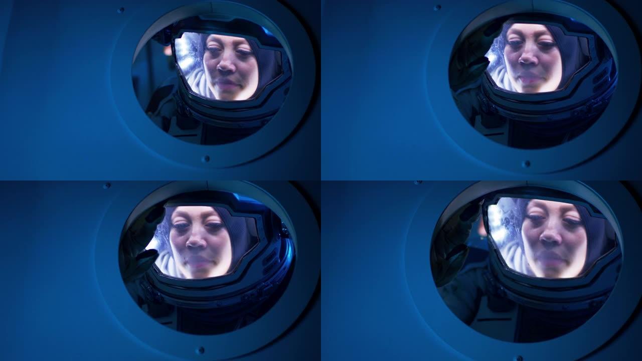 女宇航员从飞船舷窗里望去