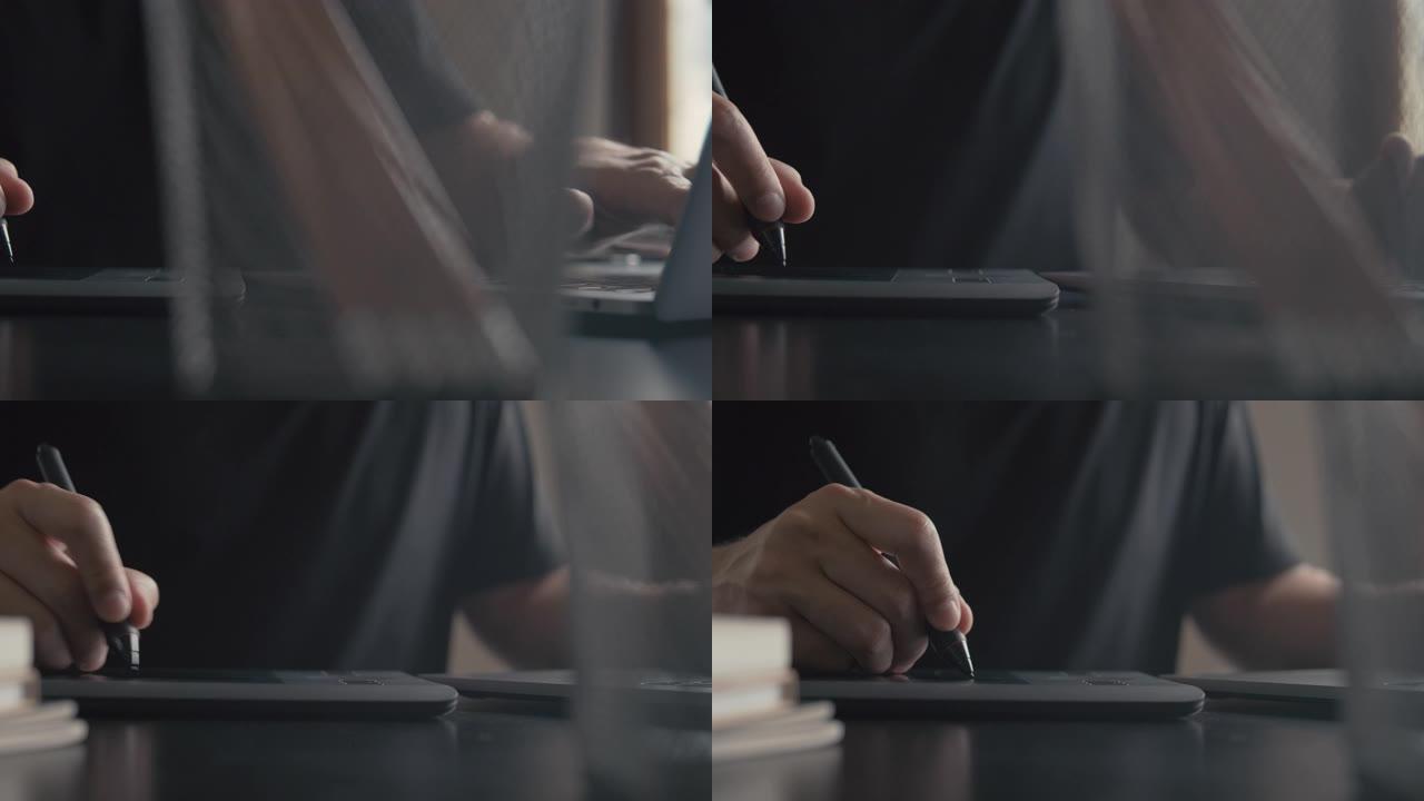 平面设计师illustrator在带有图形平板电脑的笔记本电脑上工作。