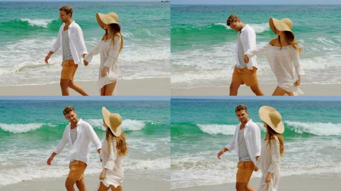 高加索夫妇在海滩上手拉手散步的侧视图4k
