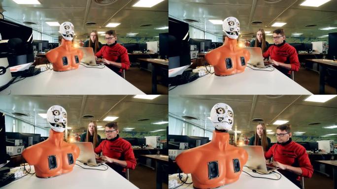 在实验室里控制机器人的女人和男人，特写。