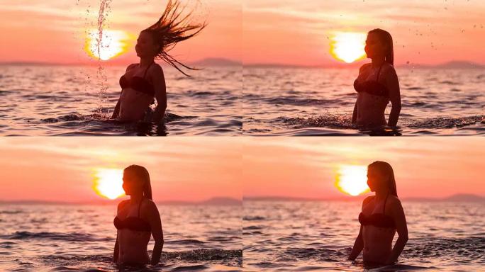 微笑的女人在做头发翻转，日落时泼水