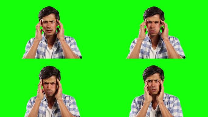 头痛和绿色屏幕的高加索人的前视图