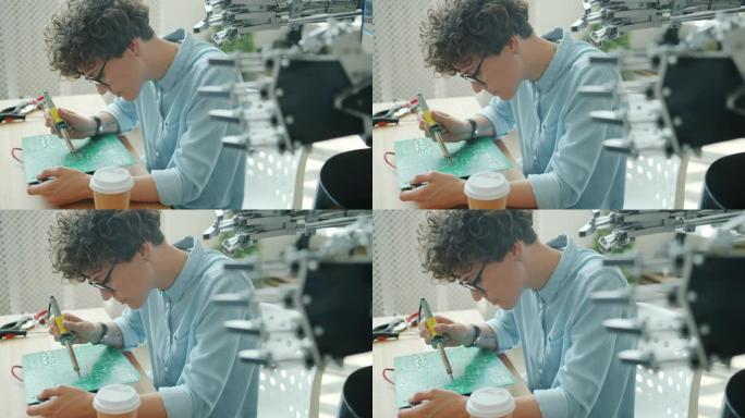 机器人工程师在工作室用烙铁制造机器人微电路