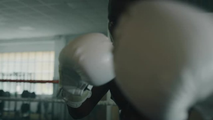 一个专业的年轻肌肉光着膀子的男人的电影镜头正在带戒指的健身房练习太极拳