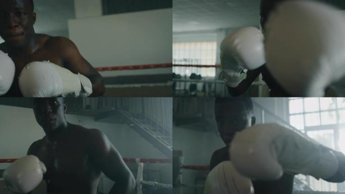 一个专业的年轻肌肉光着膀子的男人的电影镜头正在带戒指的健身房练习太极拳