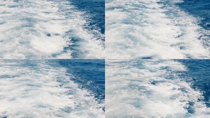 美丽的背景拍摄白色船跟踪海泡沫闪耀白色后，大游船在阳光明媚的日子航行。