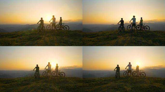 慢动作: 一群骑自行车的fit游客观察金色的日出。