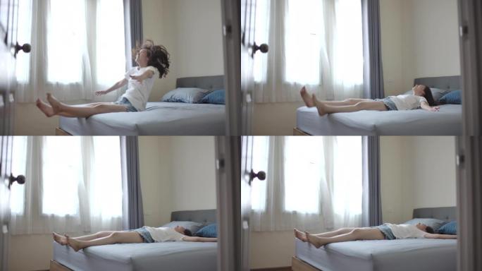 亚洲女人在假期跳上床，在房间里放松