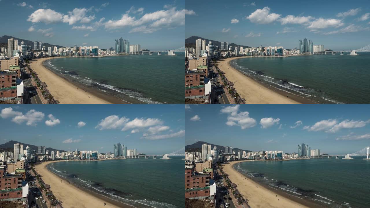 韩国釜山市海云台海滩。汽车交通、云、行走的人和海浪的时间流逝。