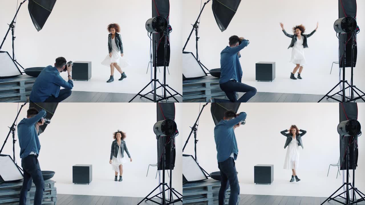 迷人的混血女士与摄影师一起在摄影棚里为相机跳跃摆姿势