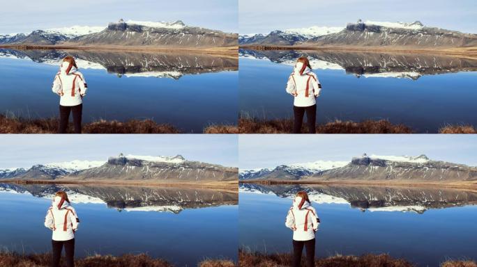 WS女人看着冰岛阳光明媚，风景秀丽的山景和湖景