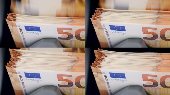 橙色欧元纸币在柜台机器中移动，检查。