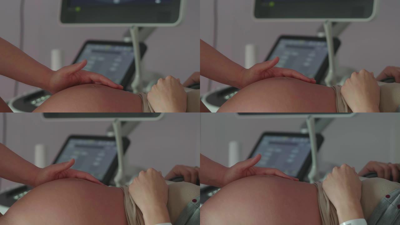 护士手的真实特写镜头在医院的产房分娩时，在宫缩过程中抚摸着一名年轻孕妇的腹部。