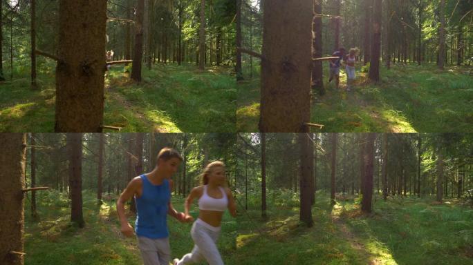 特写: 在阳光明媚的日子里，运动情侣在风景如画的森林中奔跑。