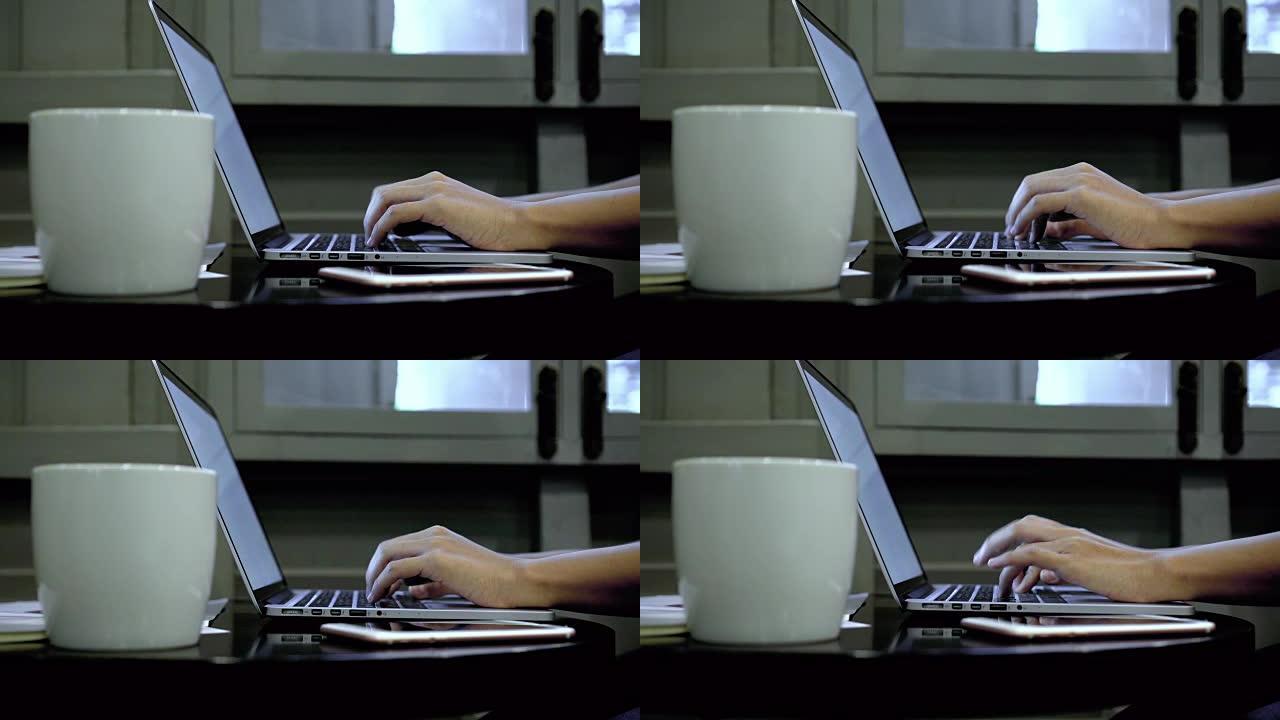 4k镜头场景特写亚洲女商人用白屏笔记本电脑工作，在咖啡馆喝咖啡，生活方式和休闲概念