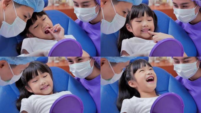 快乐的男牙医，在牙科诊所检查病人女婴的牙齿。可爱的小女孩坐在牙科椅上接受牙科治疗。医学、口腔医学和保