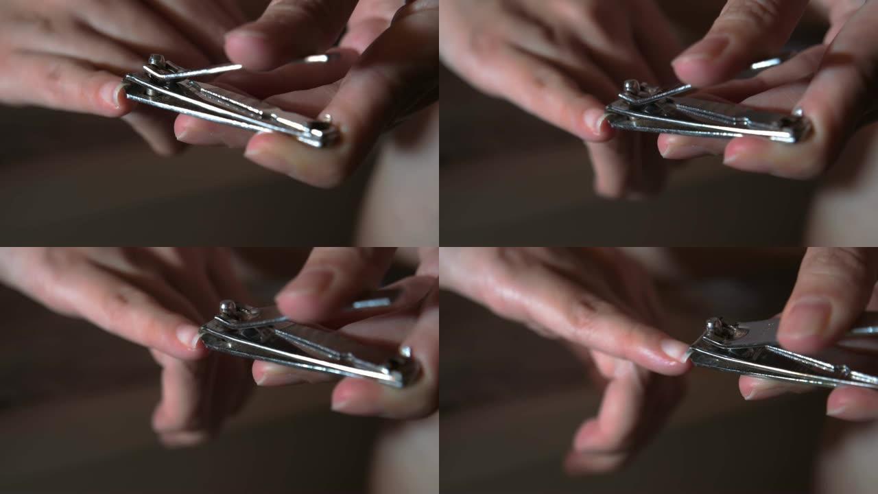 亚洲女人在家用手剪指甲。保健概念