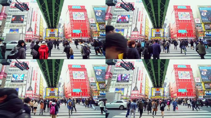 4k镜头行人人群的场景未定义的人走立交桥在日本秋叶原东京市的街道交叉路口。日本文化与电城购物区概念