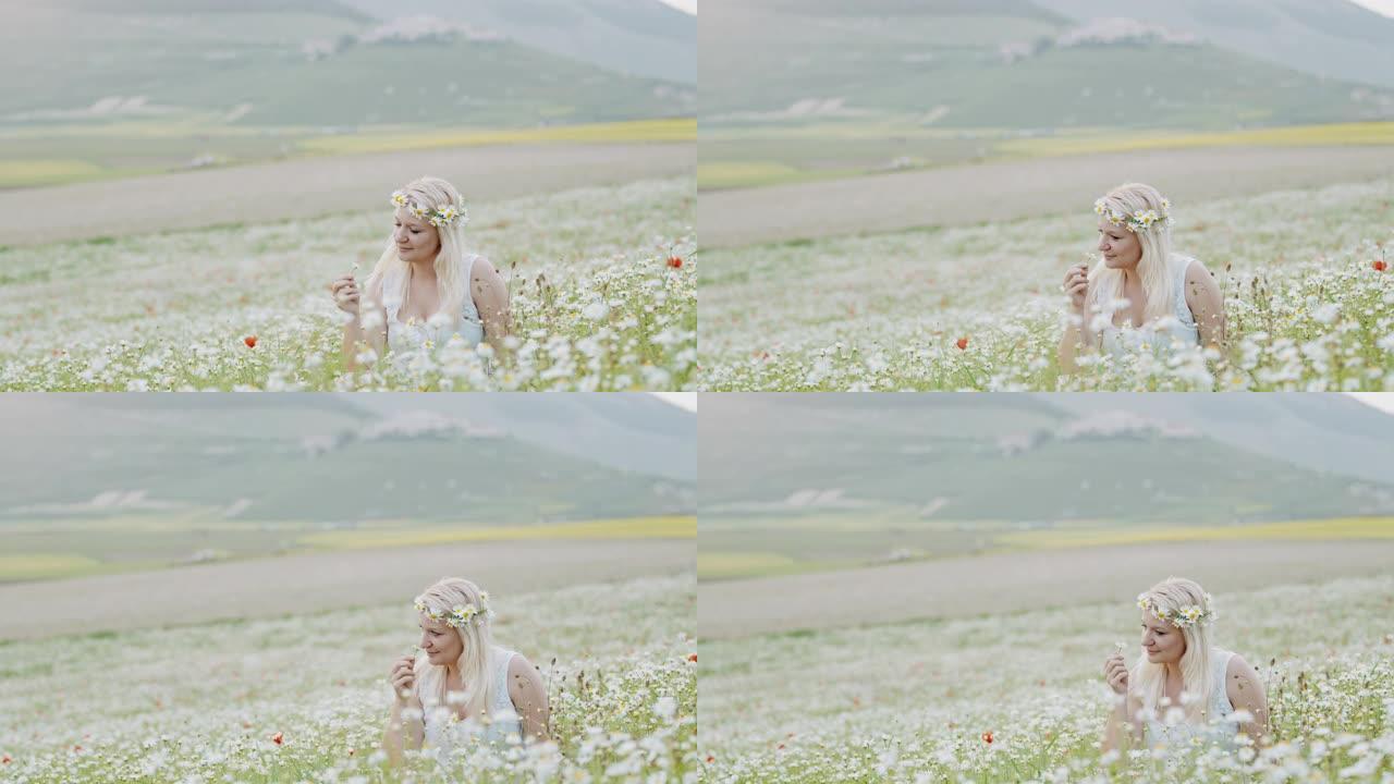女士在意大利翁布里亚的Castelluccio的雏菊草地上戴着花冠的宁静年轻女子