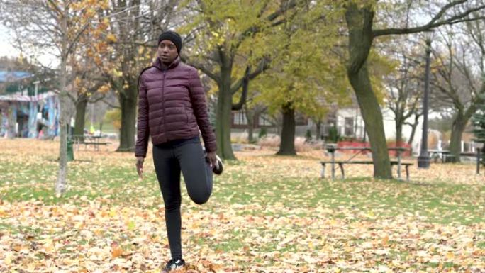 一个成年的非洲人在锻炼前伸展和专注