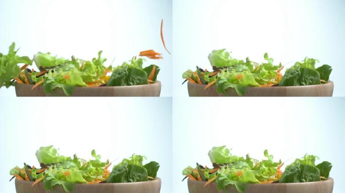 蔬菜在搅拌沙拉碗上慢动作掉落。