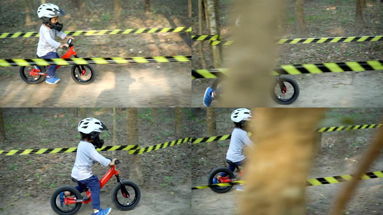 侧视幼儿在土路骑平衡自行车。