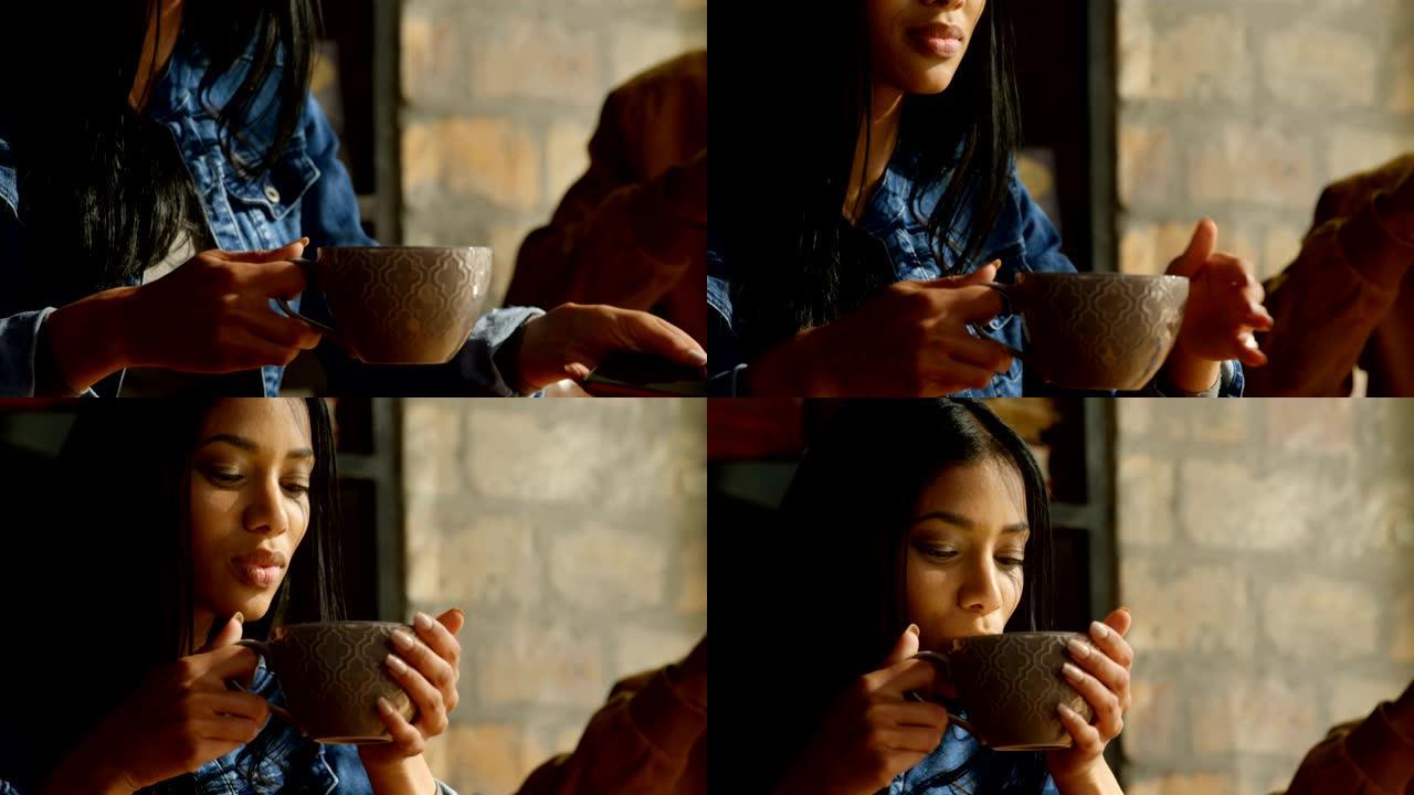 咖啡馆4k年轻漂亮混血女人喝咖啡用手机特写
