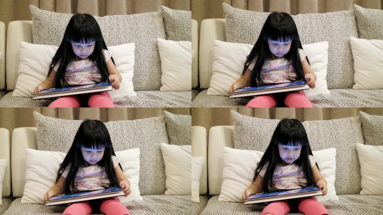 小女孩在数字平板电脑上玩和看网络媒体，慢动作