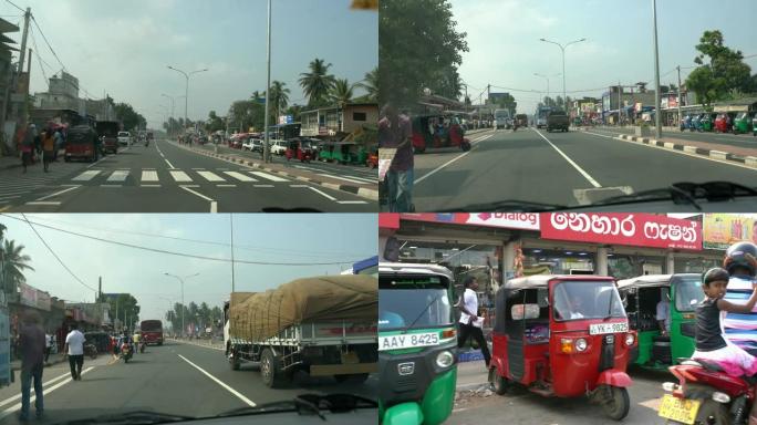 斯里兰卡繁忙，阳光明媚的街道上的MS汽车，公共汽车，人力车和自行车