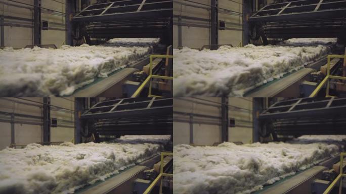 沿生产线移动的蓬松矿棉原料