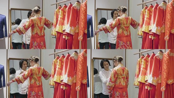 中国婚纱设计师在工作室装修新娘