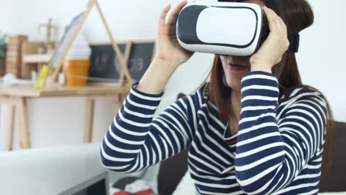 女人在家中使用带笔记本电脑的VR眼镜