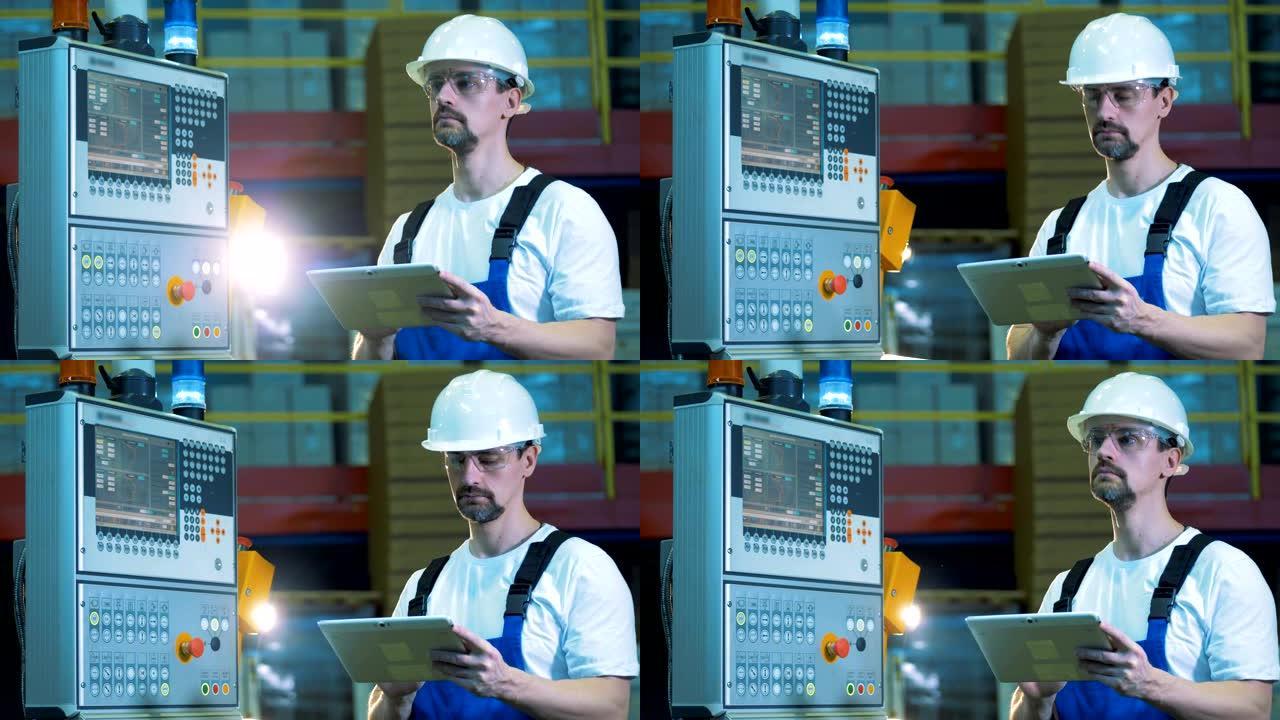 工业工程师在监控控制台旁边操作笔记本电脑