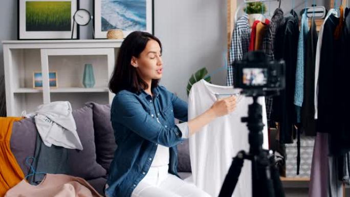 女性造型师在家为interner vlog录制现代服装视频