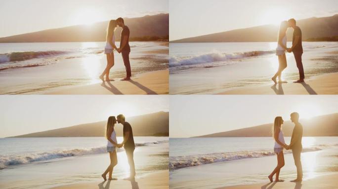 迷人的情侣在海滩上接吻