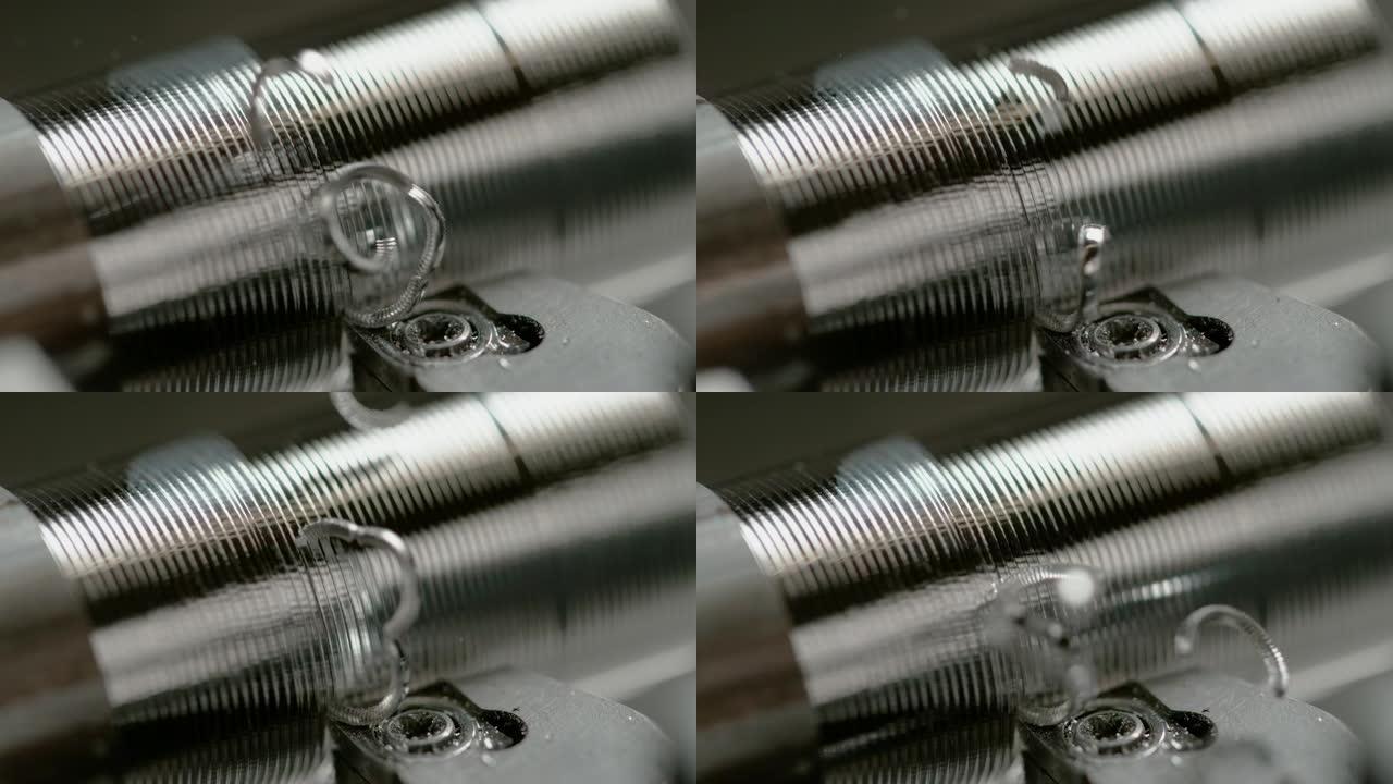 宏观: 螺旋形切屑从铝棒上飞下来，被加工成螺栓