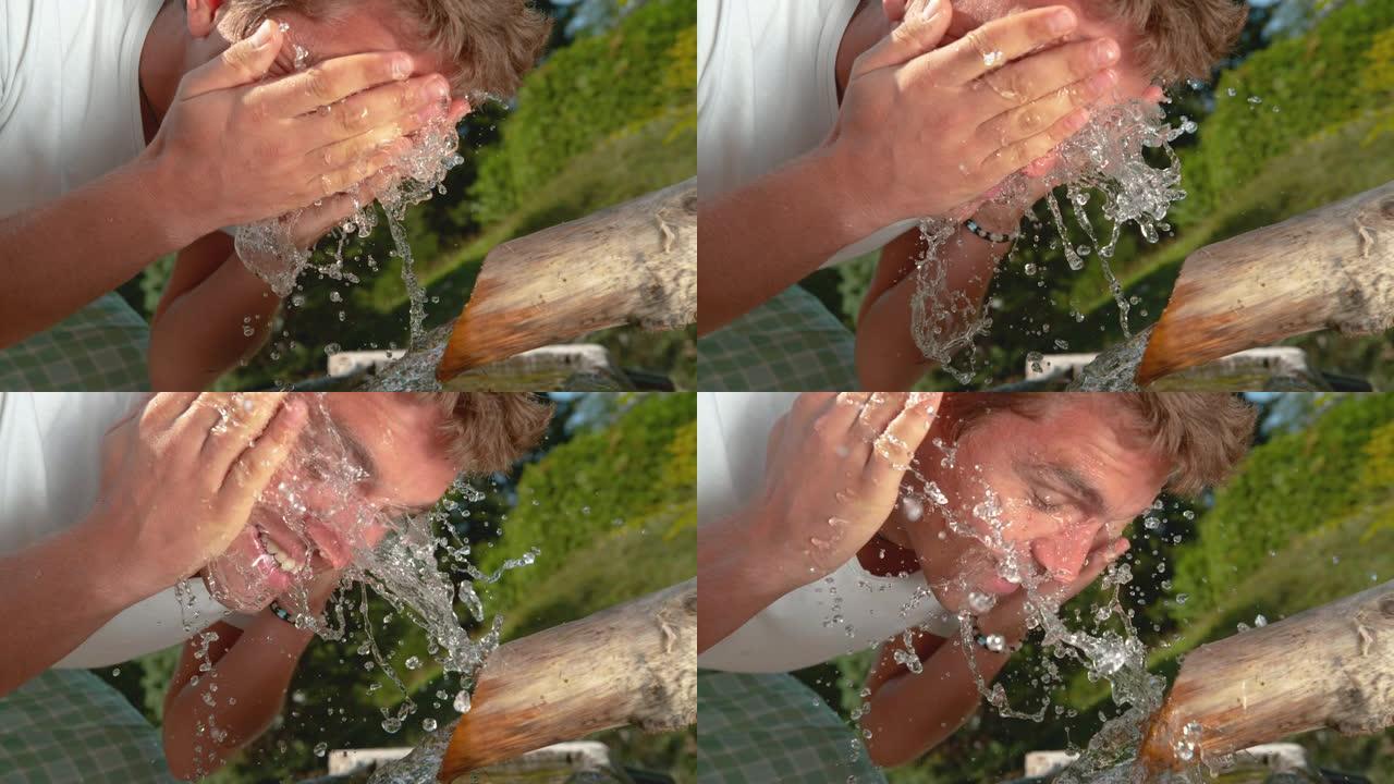 慢动作效果: 快乐男人用清爽的凉水洗脸。
