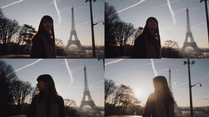 镜头耀斑肖像美丽微笑的旅游女人在史诗般的日落巴黎埃菲尔铁塔上摆姿势度假慢动作。