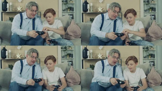 孙子正在向他的爷爷解释如何玩游戏机