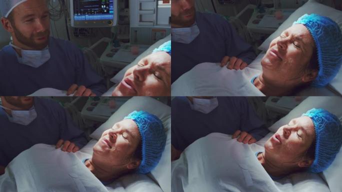 高加索男子在手术室分娩时安慰孕妇的特写