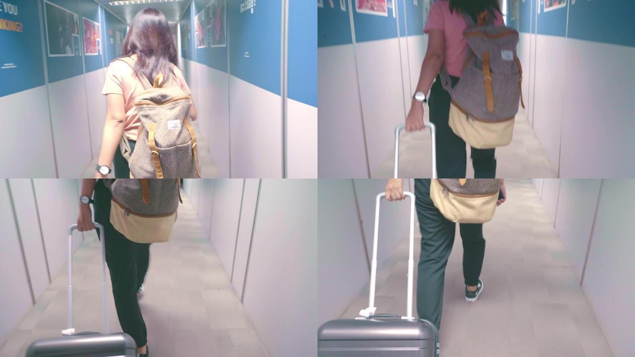 到达机场的妇女登机行李箱旅途