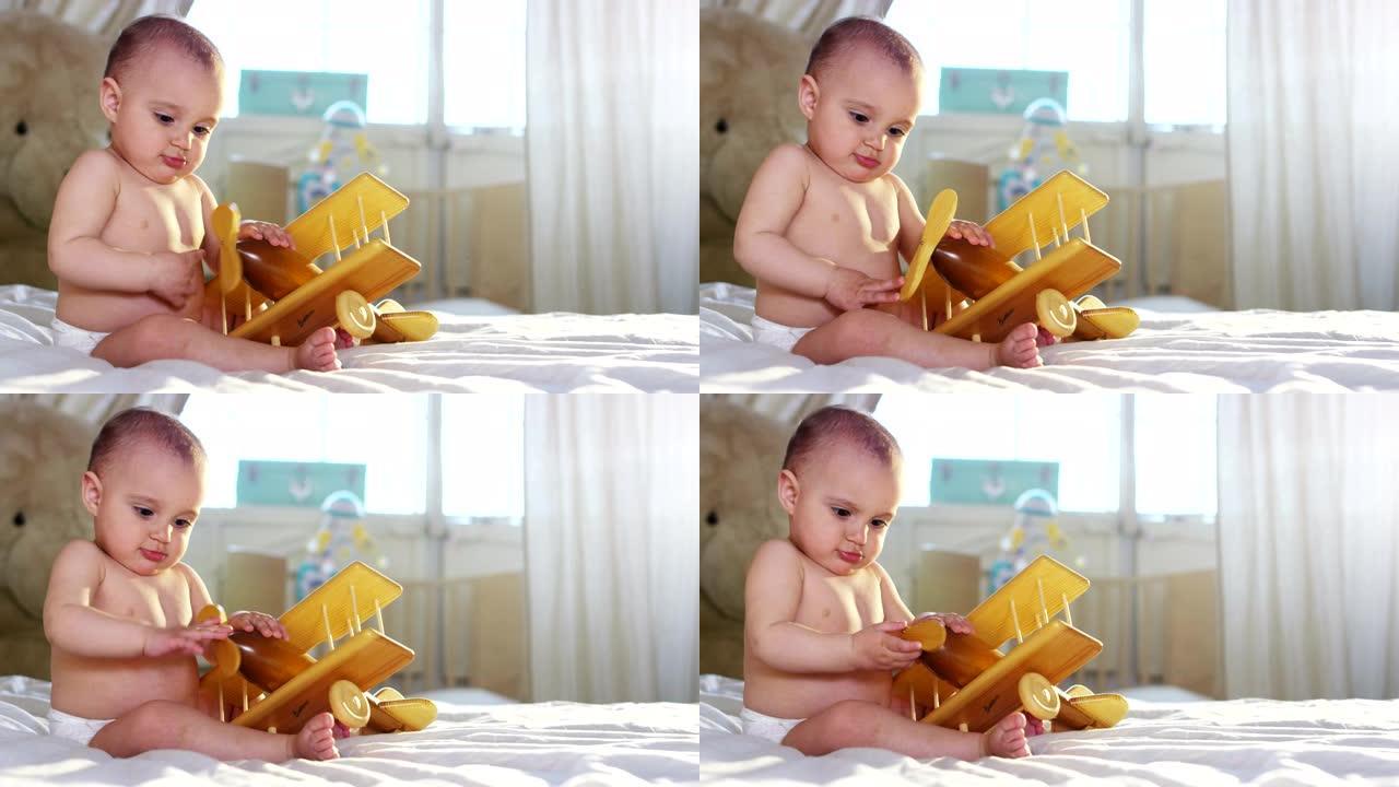 一个可爱的小宝宝看着相机，很高兴宝宝环顾四周，用手臂玩耍