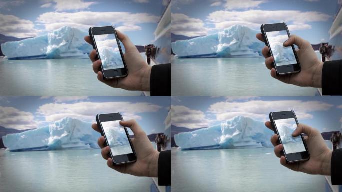 在佩里托莫雷诺冰川冰山附近的一艘旅游船上，男性双手拿着一台旧智能手机。