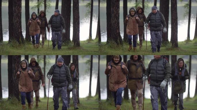 高级徒步旅行者在雨中交谈和穿越森林