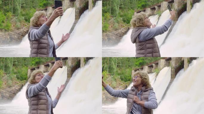 高级妇女在溢洪道前进行视频通话